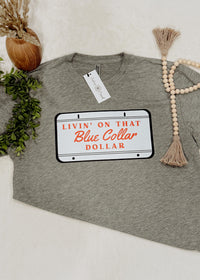 Gray t-shirt with a license plate graphic and text on a white background